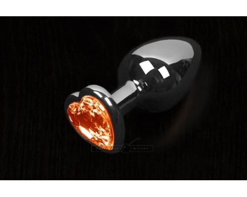 Пикантные Штучки Большая серебристая анальная пробка с кристаллом в виде сердечка 8,5Х4 см (оранжевый)